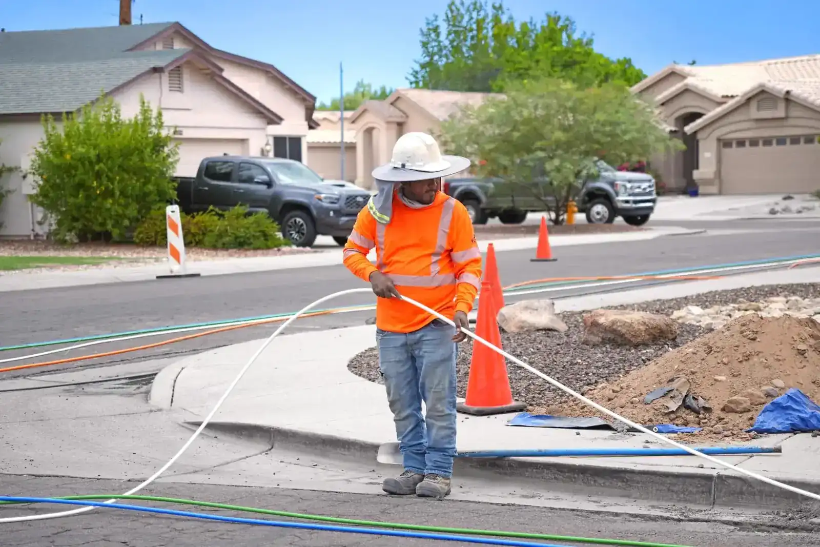 Crew setting a fiber vault at the curb